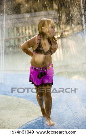 Girl standing under a shower View Large Photo Image Stock Photo - Girl standing under a shower. Fotosearch