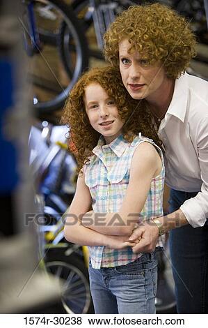 Girl with her mother in a bicycle shop View Large Photo Image Stock Photo - Girl with her mother in a bicycle shop. Fotosearch