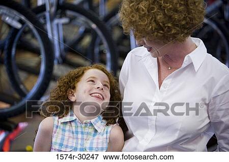 Girl with her mother in a bicycle shop View Large Photo Image Stock Photo - Girl with her mother in a bicycle shop. Fotosearch