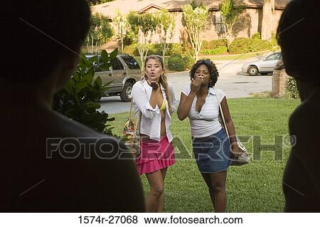 Girlfriends giving flying kiss to their boyfriends View Large Photo Image Stock Photo - Girlfriends giving flying kiss to their boyfriends. Fotosearch
