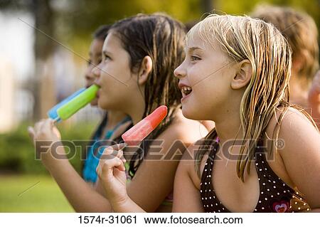 Girls eating flavored ice View Large Photo Image Stock Image - Girls eating flavored ice. Fotosearch