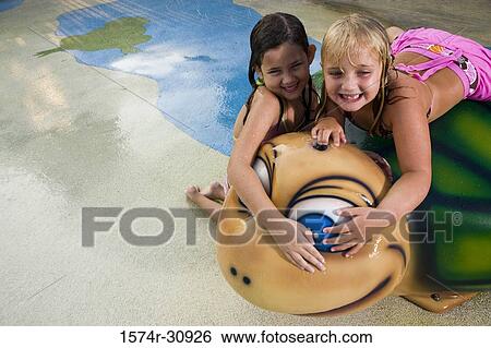 Girls lying together on a tortoise sculpture View Large Photo Image Stock Photograph - Girls lying together on a tortoise sculpture. Fotosearch