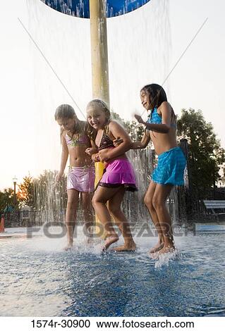Girls standing together under a shower View Large Photo Image Stock Image - Girls standing together under a shower. Fotosearch