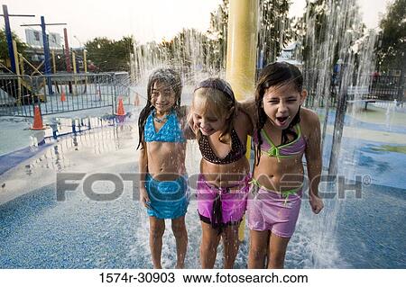 Girls standing together under a shower View Large Photo Image Stock Image - Girls standing together under a shower. Fotosearch