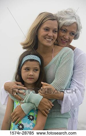 Grandmother embracing with her daughter and granddaughter at the beach View Large Photo Image Stock Photography - Grandmother embracing with her daughter and granddaughter at the beach. Fotosearch