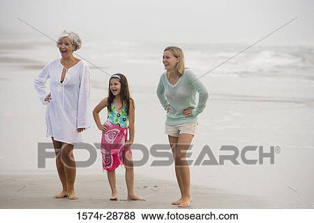 Grandmother enjoying with her daughter and granddaughter at the beach View Large Photo Image Stock Photo - Grandmother enjoying with her daughter and granddaughter at the beach. Fotosearch