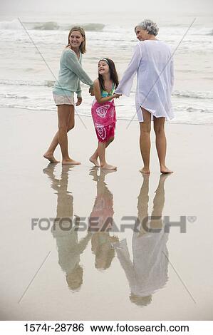 Grandmother enjoying with her daughter and granddaughter at the beach View Large Photo Image Stock Photograph - Grandmother enjoying with her daughter and granddaughter at the beach. Fotosearch