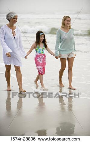Grandmother enjoying with her daughter and granddaughter at the beach View Large Photo Image Stock Photograph - Grandmother enjoying with her daughter and granddaughter at the beach. Fotosearch