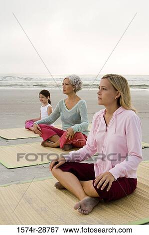 Grandmother exercising with daughter and granddaughter on a mat at the beach View Large Photo Image Stock Photo - Grandmother exercising with daughter and granddaughter on a mat at the beach. Fotosearch