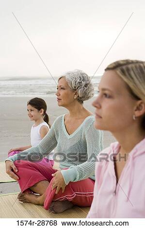 Grandmother exercising with daughter and granddaughter on a mat at the beach View Large Photo Image Stock Photo - Grandmother exercising with daughter and granddaughter on a mat at the beach. Fotosearch
