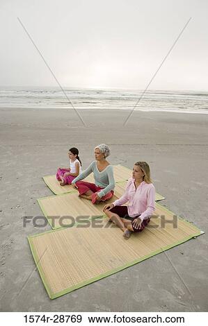 Grandmother exercising with daughter and granddaughter on a mat at the beach View Large Photo Image Stock Photo - Grandmother exercising with daughter and granddaughter on a mat at the beach. Fotosearch