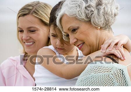 Grandmother with her daughter and granddaughter enjoying at the beach View Large Photo Image Picture - Grandmother with her daughter and granddaughter enjoying at the beach. Fotosearch