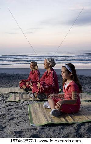 Grandmother with her daughter and granddaughter exercising at the beach View Large Photo Image Stock Image - Grandmother with her daughter and granddaughter exercising at the beach. Fotosearch