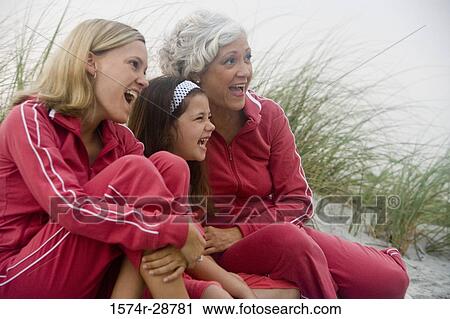 Grandmother with her daughter and granddaughter sitting at the beach View Large Photo Image Stock Image - Grandmother with her daughter and granddaughter sitting at the beach. Fotosearch