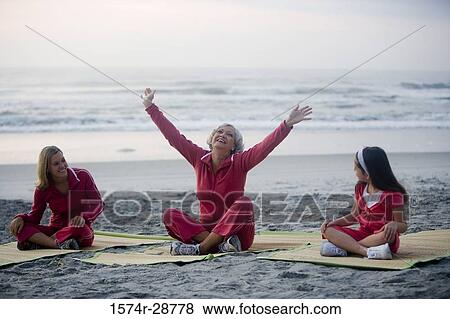 Grandmother with her daughter and granddaughter exercising at the beach View Large Photo Image Stock Photo - Grandmother with her daughter and granddaughter exercising at the beach. Fotosearch