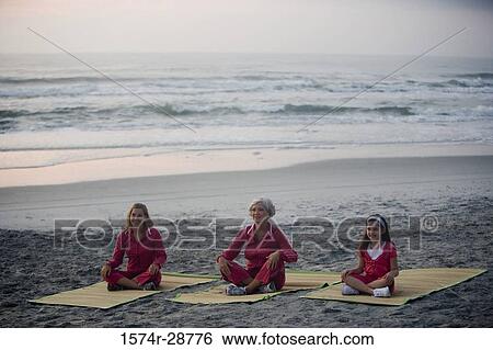 Grandmother with her daughter and granddaughter exercising at the beach View Large Photo Image Stock Photograph - Grandmother with her daughter and granddaughter exercising at the beach. Fotosearch