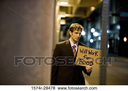 Stock Photo - Jobless man holding a placard. Fotosearch