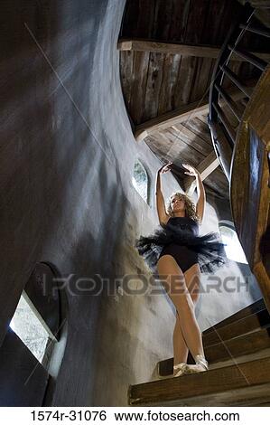 Stock Photograph - Low angle view of a ballet dancer practicing on a wooden staircase. Fotosearch