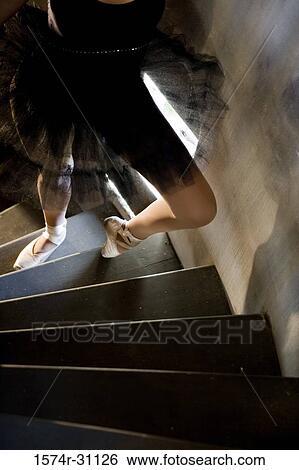 Stock Photograph - Low section of a ballet dancer climbing up wooden steps. Fotosearch