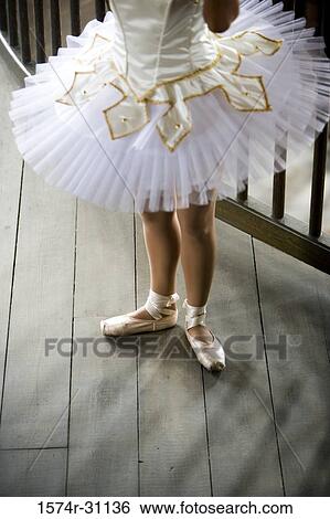 Stock Photograph - Low section of a ballet dancer standing. Fotosearch