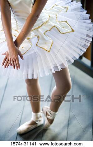 Stock Image - Low section of a young woman practicing ballet dancing. Fotosearch