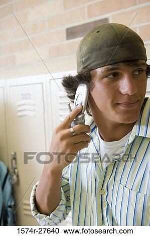 Stock Image - Male student communicating on mobile phone. Fotosearch