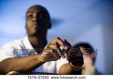 Male student with focus on hands in the classroom View Large Photo Image Stock Image - Male student with focus on hands in the classroom. Fotosearch