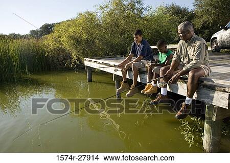 Man fishing with his son and friend on jetty View Large Photo Image Picture - Man fishing with his son and friend on jetty. Fotosearch
