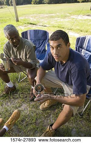 Man sitting with his friend on chair at forest View Large Photo Image Stock Image - Man sitting with his friend on chair at forest. Fotosearch