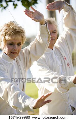 Mature couple performing martial arts in the park View Large Photo Image Stock Image - Mature couple performing martial arts in the park. Fotosearch