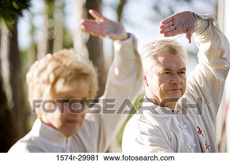 Mature couple performing martial arts in the park View Large Photo Image Stock Image - Mature couple performing martial arts in the park. Fotosearch