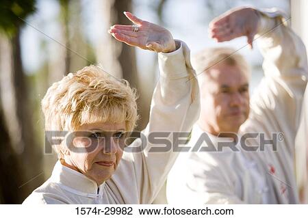 Mature couple performing martial arts in the park View Large Photo Image Stock Image - Mature couple performing martial arts in the park. Fotosearch
