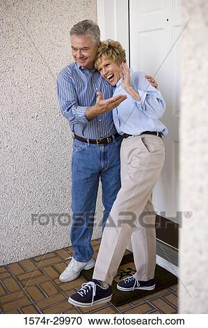 Mature couple standing together and smiling View Large Photo Image Stock Image - Mature couple standing together and smiling. Fotosearch