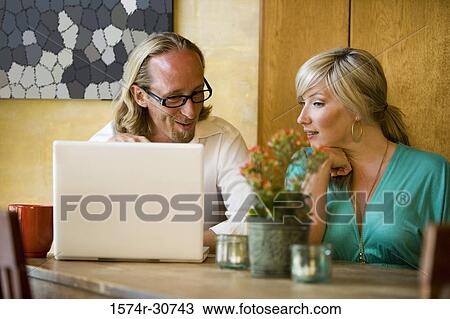 Mature couple using a laptop together View Large Photo Image Stock Image - Mature couple using a laptop together. Fotosearch