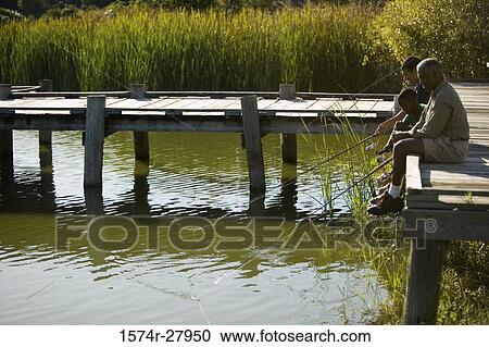 Mature man fishing with his son and friend by lake View Large Photo Image Stock Image - Mature man fishing with his son and friend by lake. Fotosearch