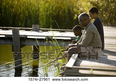 Mature man fishing with his son and friend by lake View Large Photo Image Stock Image - Mature man fishing with his son and friend by lake. Fotosearch