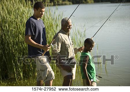 Mature man fishing with his son and friend by lake View Large Photo Image Stock Image - Mature man fishing with his son and friend by lake. Fotosearch