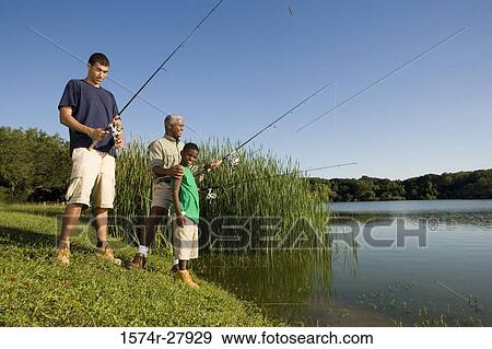 Mature man fishing with his son and friend by lake View Large Photo Image Stock Photo - Mature man fishing with his son and friend by lake. Fotosearch