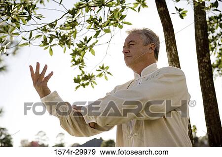 Mature man performing martial arts in the park View Large Photo Image Stock Photo - Mature man performing martial arts in the park. Fotosearch