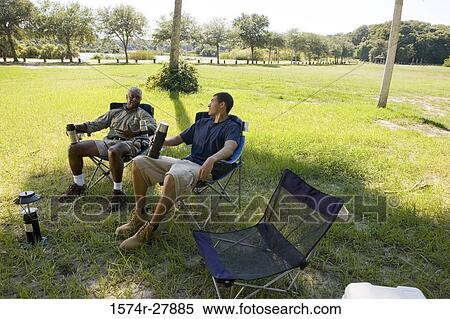 Mature man relaxing with his friend on chair at forest View Large Photo Image Stock Photography - Mature man relaxing with his friend on chair at forest. Fotosearch