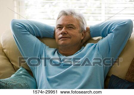Mature man sitting on a couch View Large Photo Image Stock Image - Mature man sitting on a couch. Fotosearch