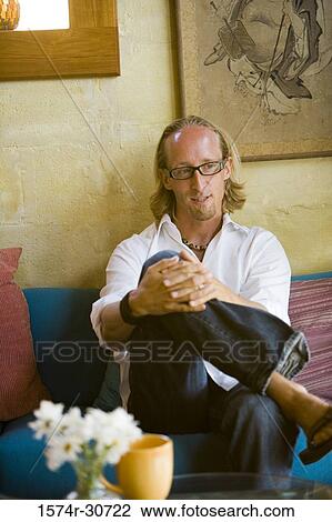 Mature man sitting with hands clasped and looking away View Large Photo Image Stock Image - Mature man sitting with hands clasped and looking away. Fotosearch