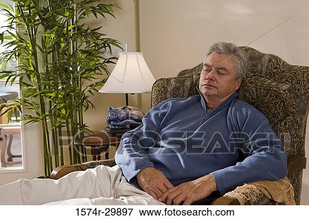 Mature man sleeping on an arm chair View Large Photo Image Stock Photo - Mature man sleeping on an arm chair. Fotosearch