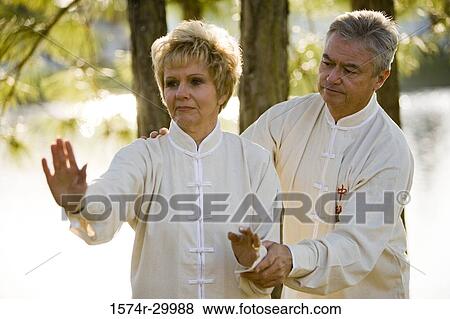 Mature man teaching martial arts to mature woman in the park View Large Photo Image Stock Photo - Mature man teaching martial arts to mature woman in the park. Fotosearch