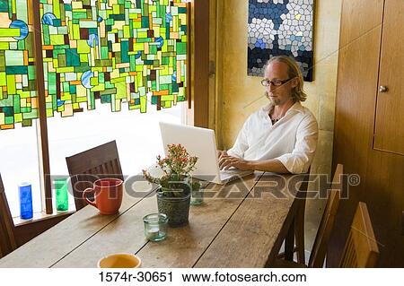 Mature man using a laptop View Large Photo Image Stock Image - Mature man using a laptop. Fotosearch