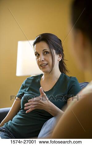 Mature woman gesturing while sitting on a sofa View Large Photo Image Stock Image - Mature woman gesturing while sitting on a sofa. Fotosearch