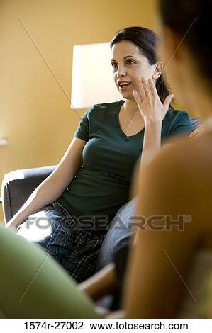 Mature woman gesturing while sitting on a sofa View Large Photo Image Stock Image - Mature woman gesturing while sitting on a sofa. Fotosearch