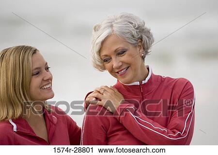 Mature woman with her daughter smiling at the beach View Large Photo Image Stock Image - Mature woman with her daughter smiling at the beach. Fotosearch