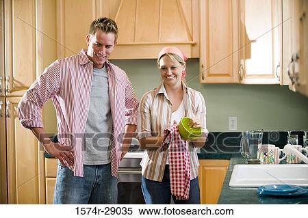 Mid adult couple cleaning bowl in the kitchen View Large Photo Image Stock Photography - Mid adult couple cleaning bowl in the kitchen. Fotosearch