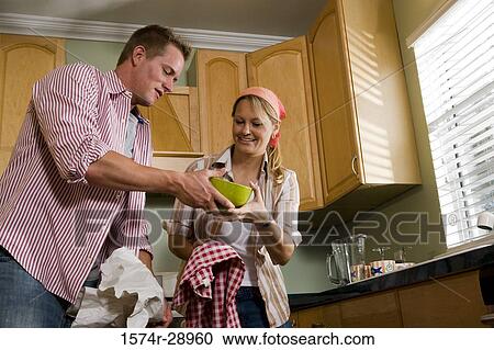 Mid adult couple cleaning jars in the kitchen View Large Photo Image Stock Image - Mid adult couple cleaning jars in the kitchen. Fotosearch